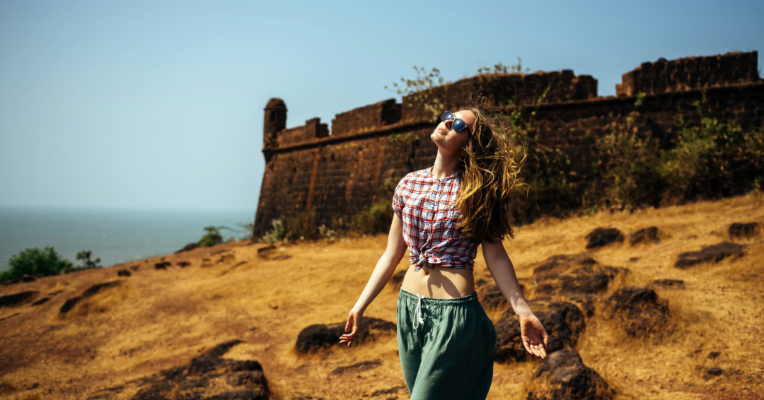 Traveller enjoying a hilltop fort view in Goa